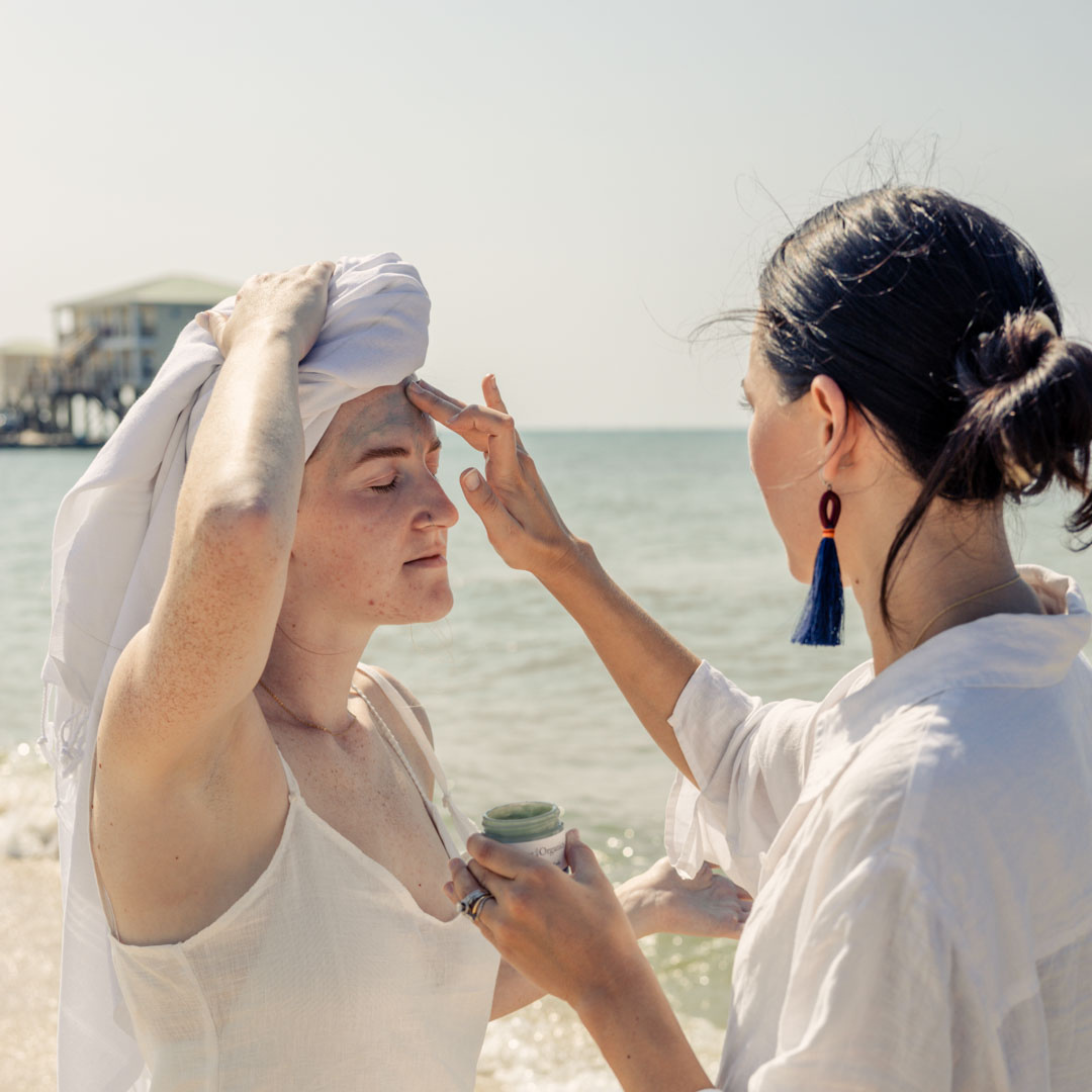 woman-applies-face-mask-for-her-friend