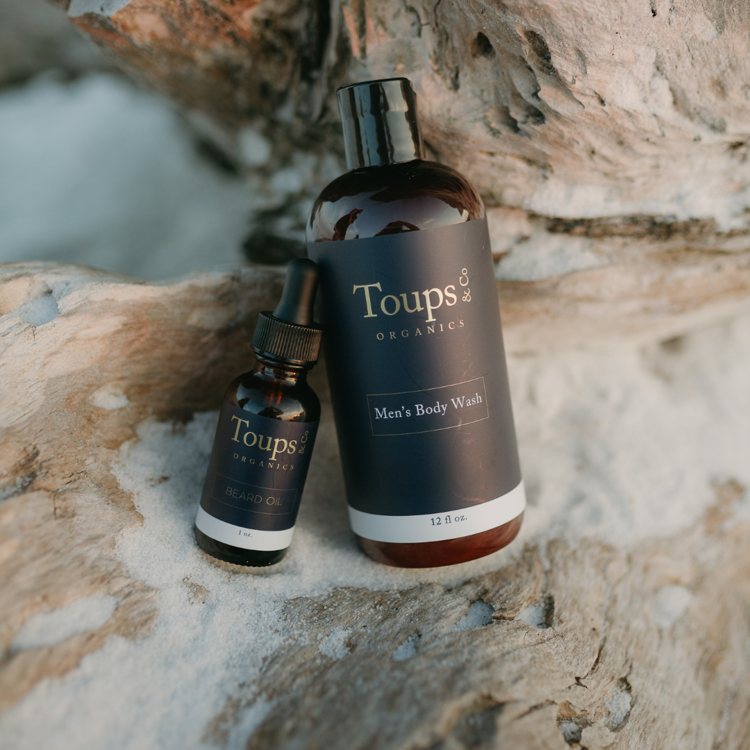mens-organic-body-wash-and-beard-oil-products-sitting-on-a-rock