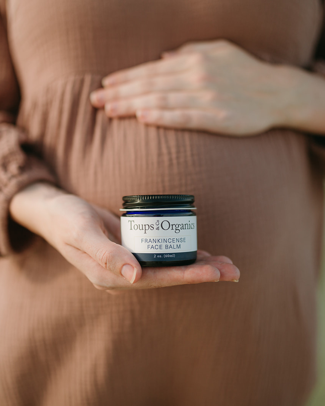 pregnant-mom-holding-tallow-balm-jar