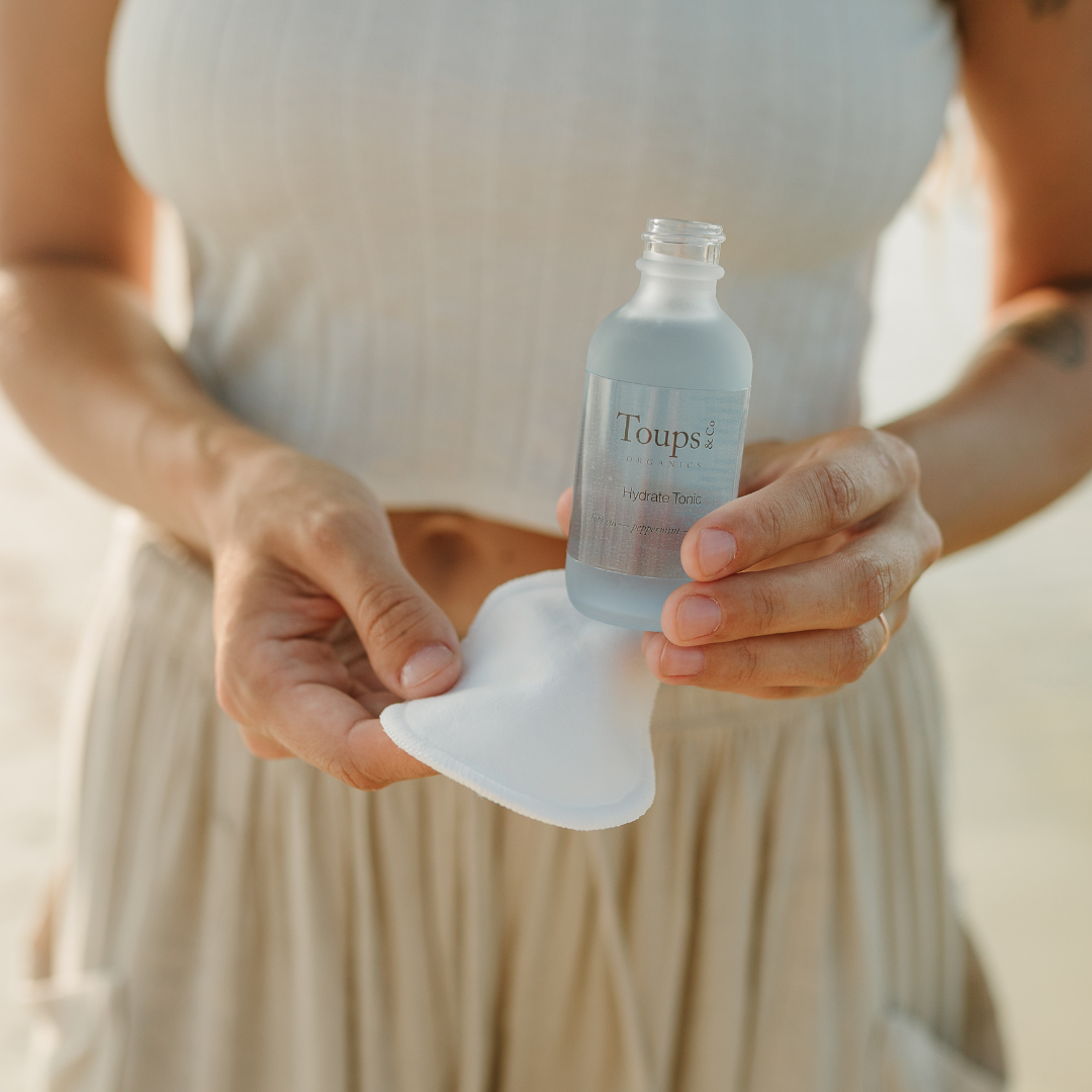 woman-holds-up-facial-tonic-for-herbal-skincare