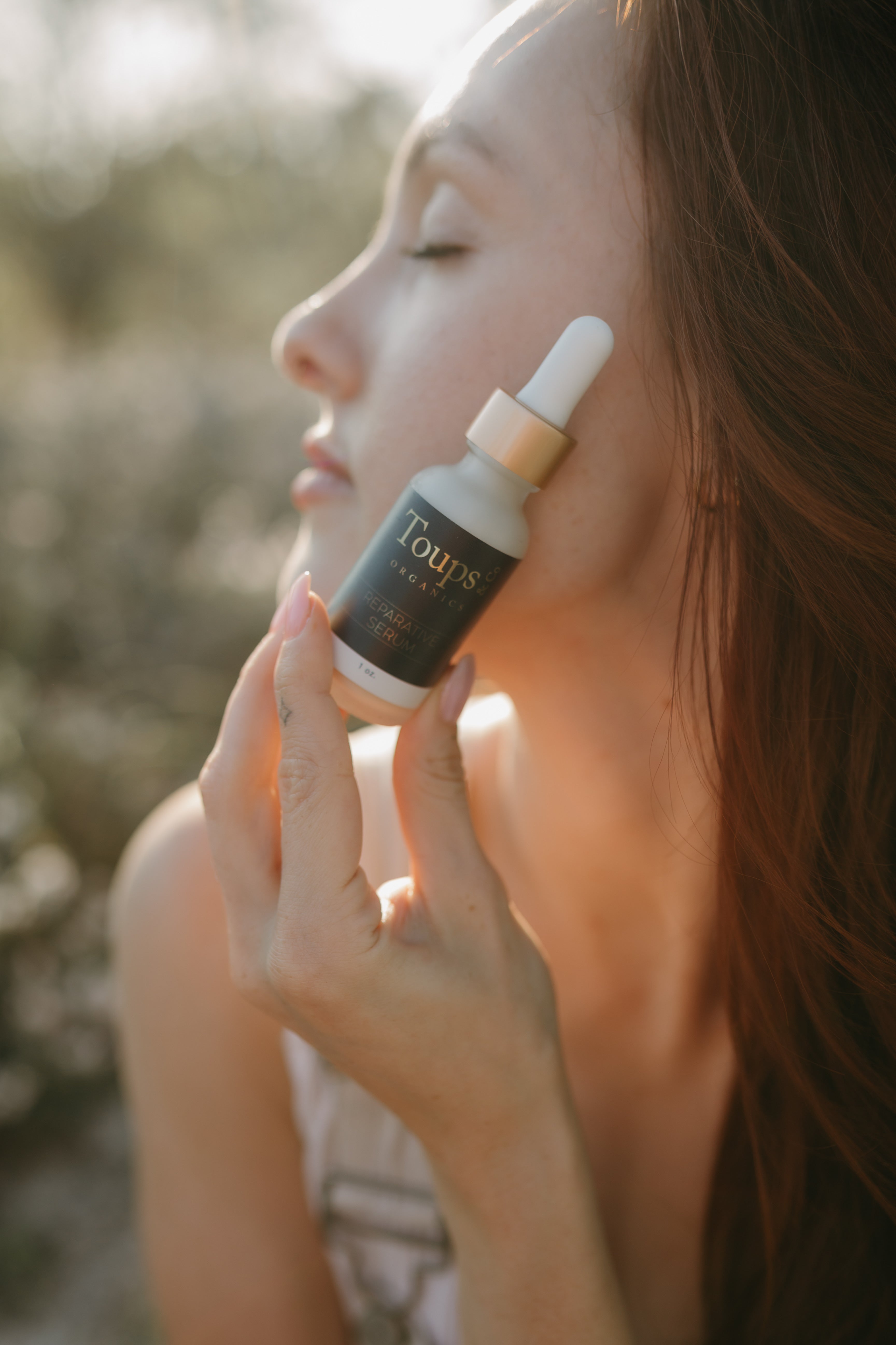 woman-holds-a-retinol-serum-up-to-her-face