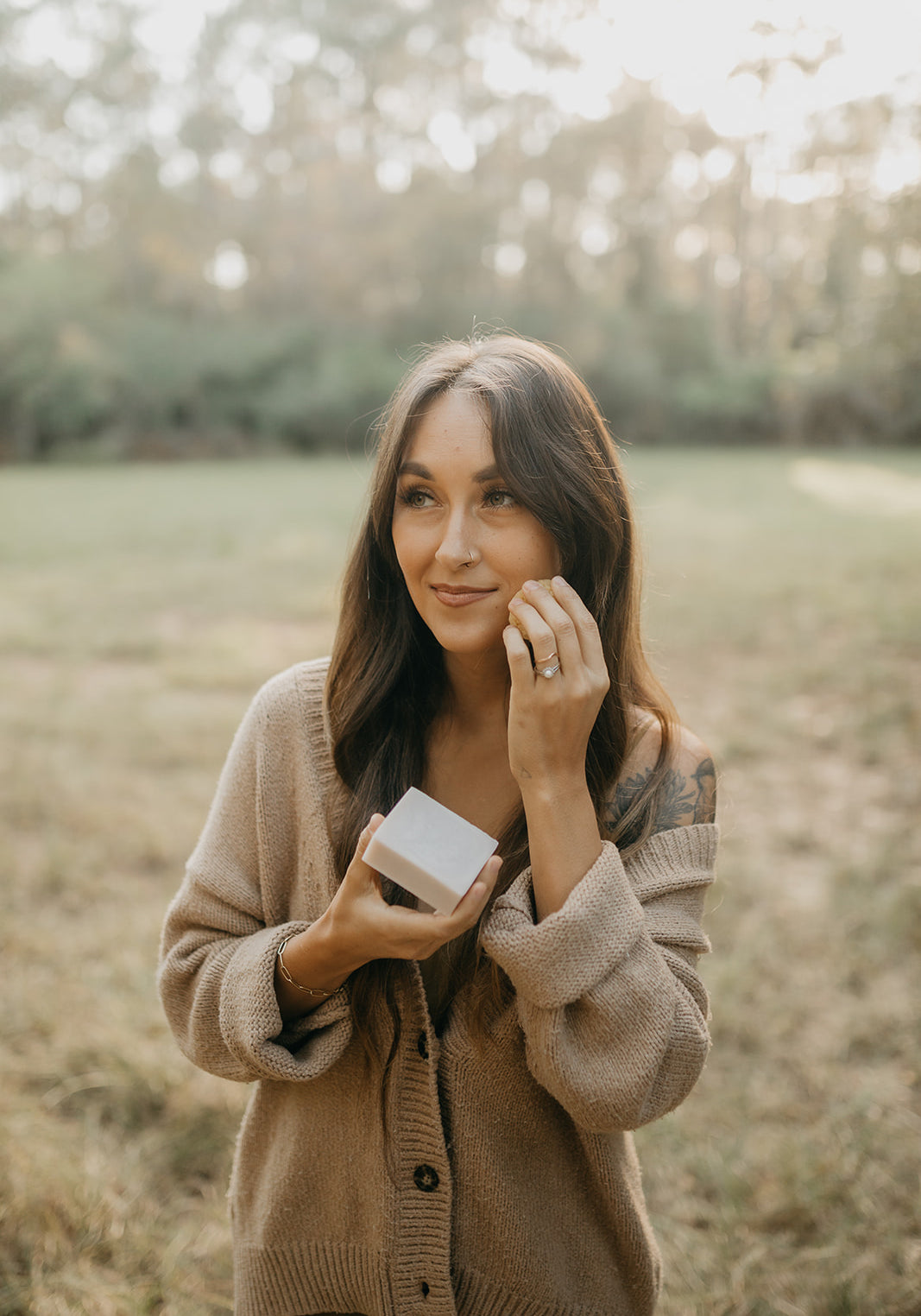woman-poses-with-a-bar-of-tallow-soap