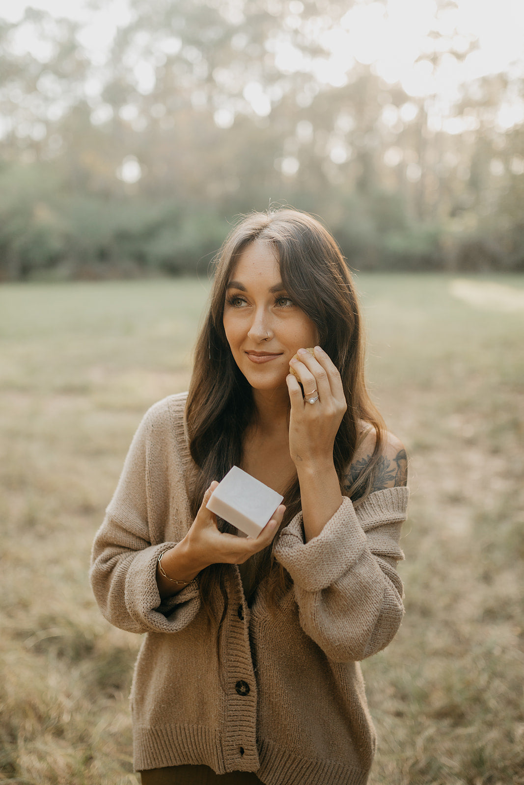 woman-poses-with-a-bar-of-tallow-soap