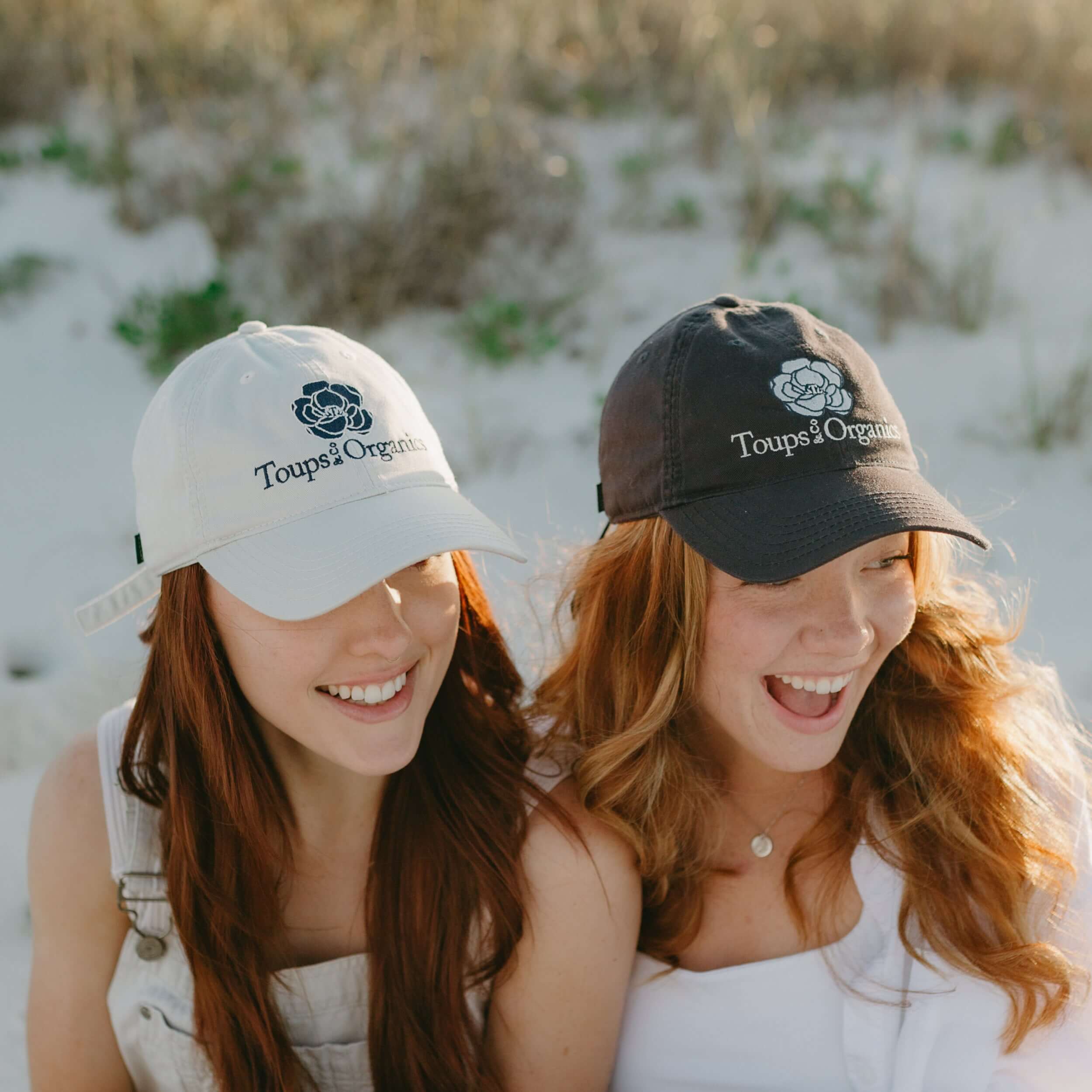 two-models-wearing-toups-and-co-hats-at-the-beach