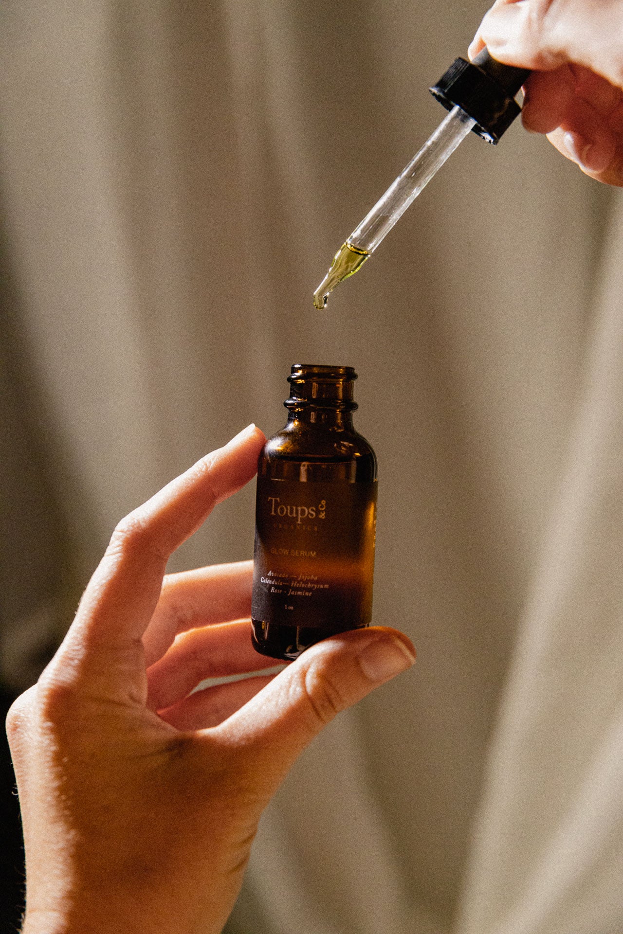 woman-pours-nontoxic-face-serum-into-bottle