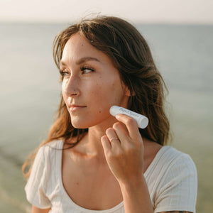 woman-applies-tallow-balm-stick-to-her-face