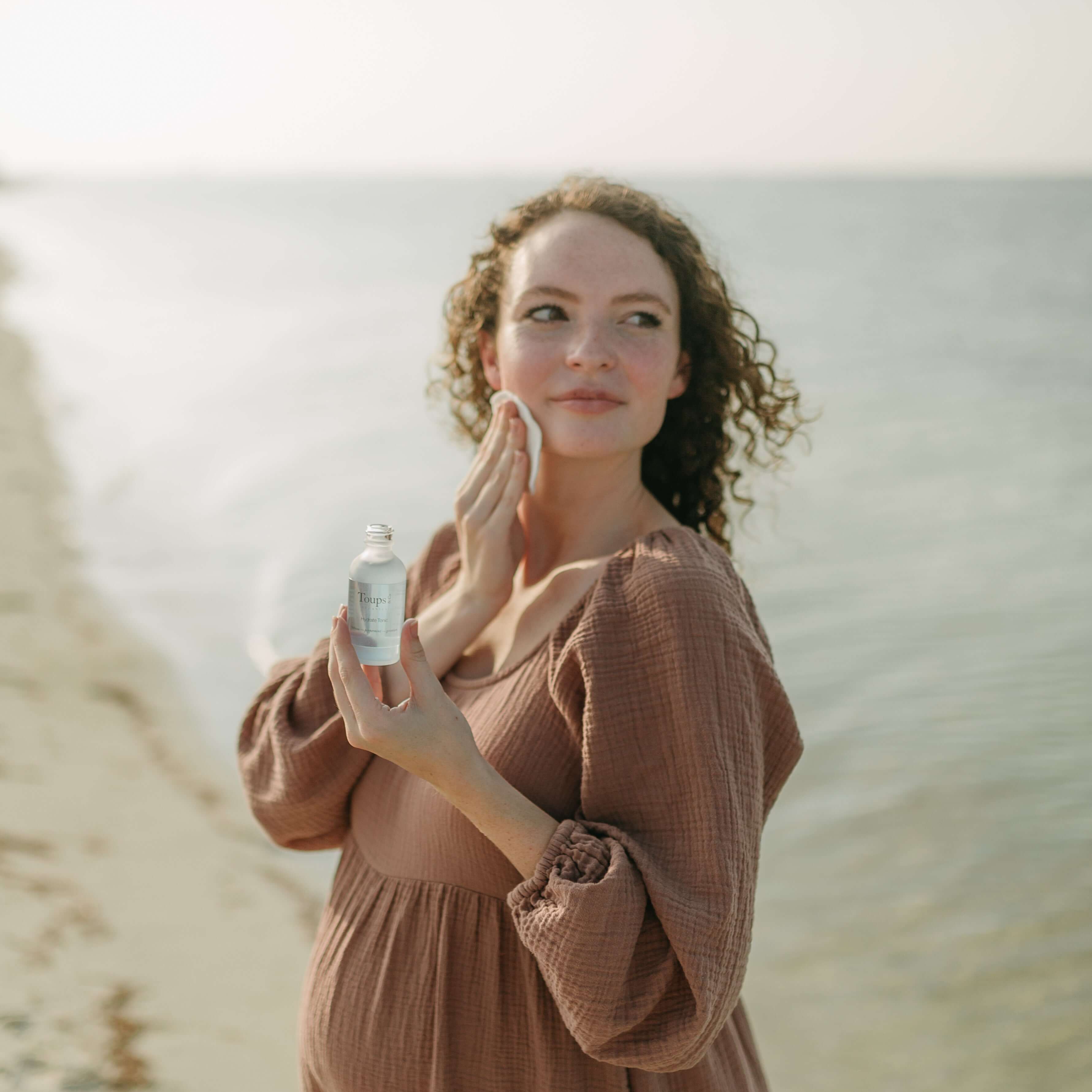 woman-applies-facial-tonic-with-a-cotton-round