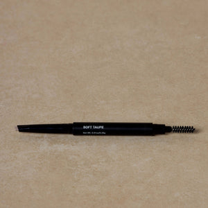 soft-taupe-eyebrow-pencil-displayed-on-brown-background-with-eyebrow-brush-on-one-end