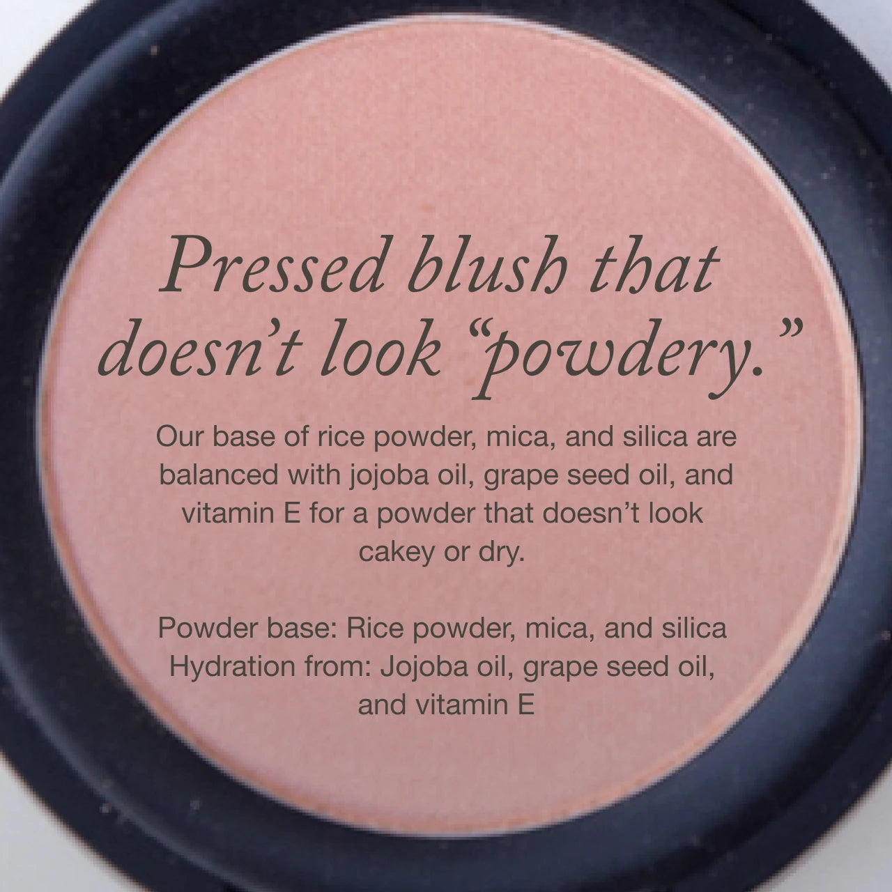 A round compact of peachy-pink pressed blush, overlaid with text describing the product as non-powdery and listing ingredients including rice powder, oils, and vitamin E.