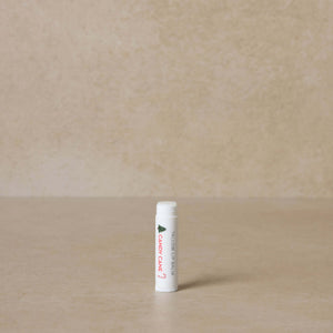 candy-cane-tallow-lip-balm-displayed-on-brown-background