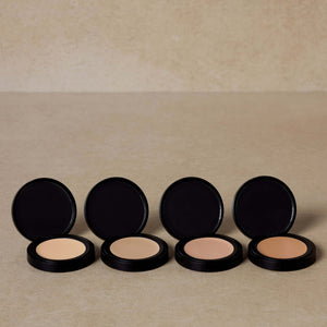 four-nontoxic-cream-concealer-shades-displayed-with-brown-background