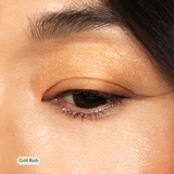 A close-up of a closed eye wearing Toups and Co Organics Natural Eyeshadow Singles in Gold Rush on the lid and brow bone—ideal for adding sparkle to sensitive skin.