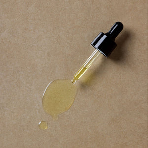 textured-photo-of-brightening-serum-on-brown-surface