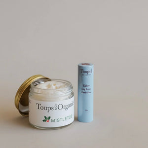 The Toups and Co Organics Merry and Bright Gift Set, featuring Organic Mistletoe Cream and Tallow Lip Love Candy Cane, makes a perfect natural skincare holiday gift.