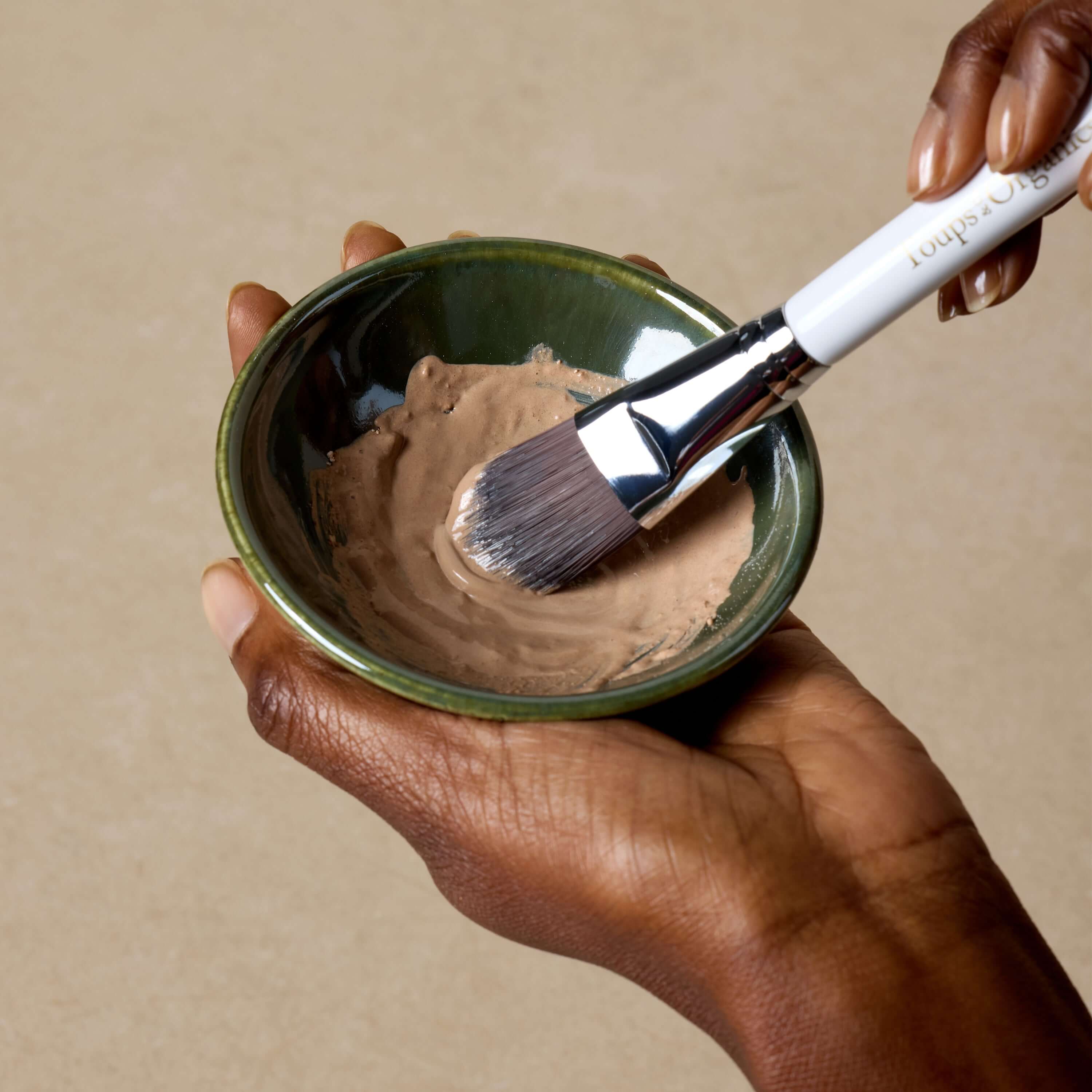woman-mixes-detox-face-mask-in-clay-bowl