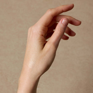 woman-shows-swatch-of-nontoxic-makeup-highlighter-on-her-arm