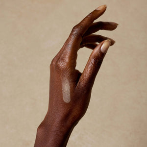 woman-shows-swatch-of-nontoxic-makeup-highlighter-on-her-arm