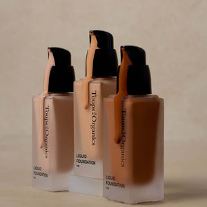 three-shades-of-nontoxic-liquid-foundation-displayed-with-one-pump-of-product-dripping-down-the-bottles