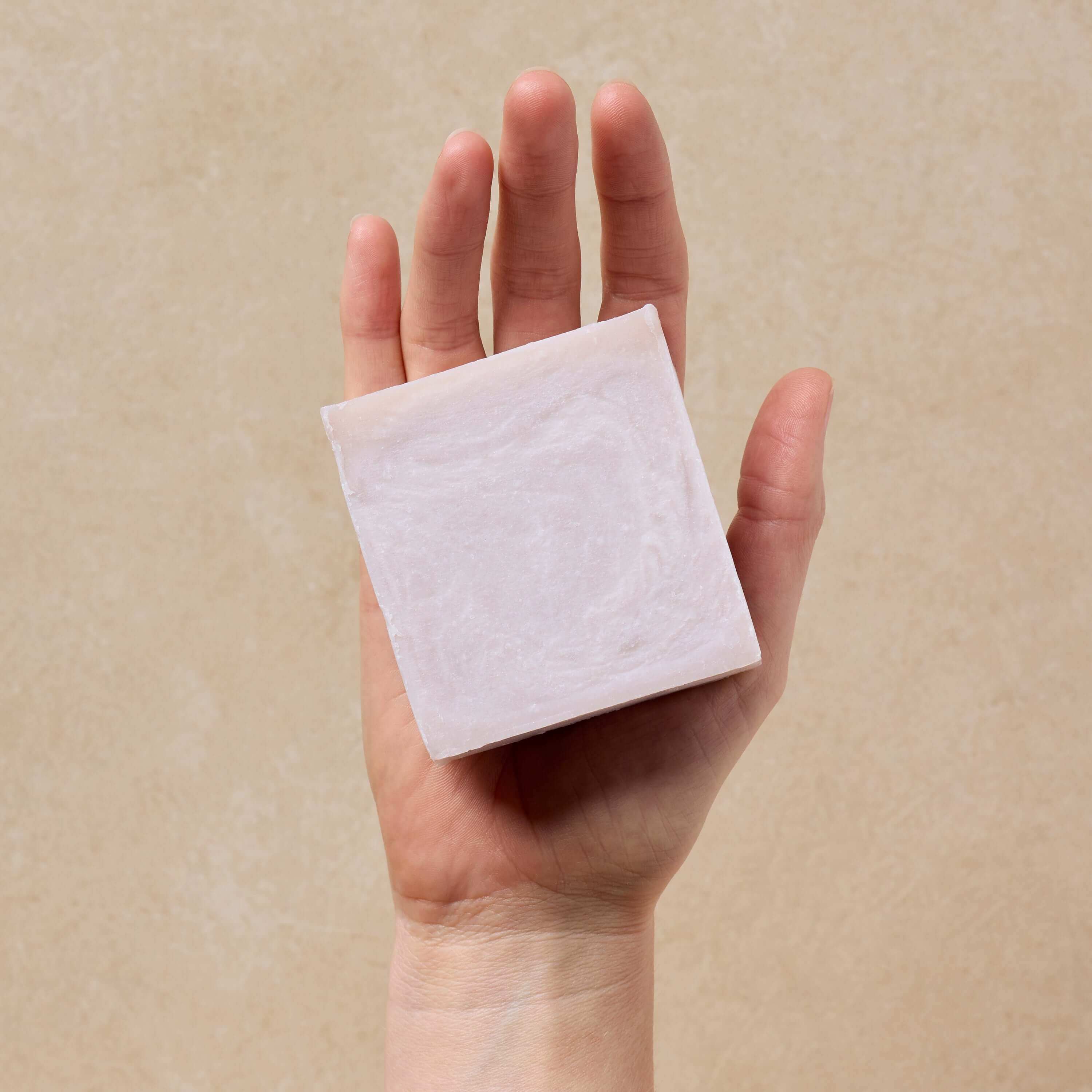 woman-holds-up-lavender-tallow-soap