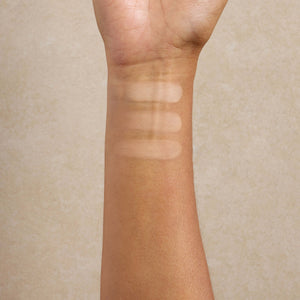 woman-displays-medium-shade-swatches-of-mineral-makeup-on-her-arm