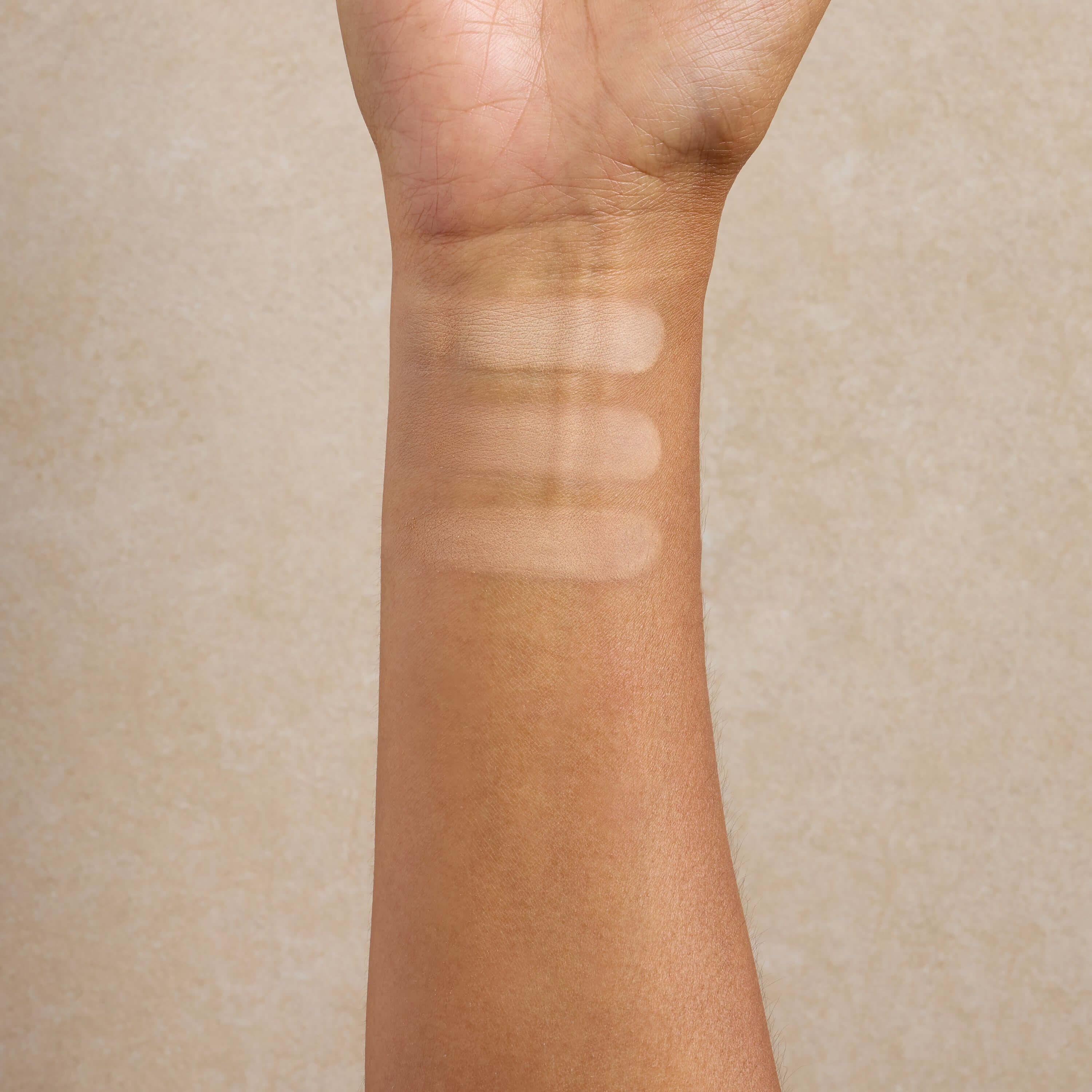 woman-displays-medium-shade-swatches-of-mineral-makeup-on-her-arm