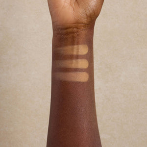 woman-displays-dark-shade-swatches-of-mineral-makeup-on-her-arm