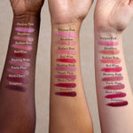 Three arms of varying skin tones show swatches of Toups and Co Organics Nourishing Lipstick, enriched with hydrating butters and antioxidants. Shades from top to bottom: Precious Pink, Breathless, Radiant Rose, Red Wine, Blushing Bride, Purely Plum, Black Cherry, Temptress.