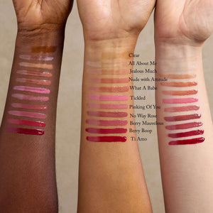 three-women-show-color-swatches-of-organic-lip-gloss-on-their-arms