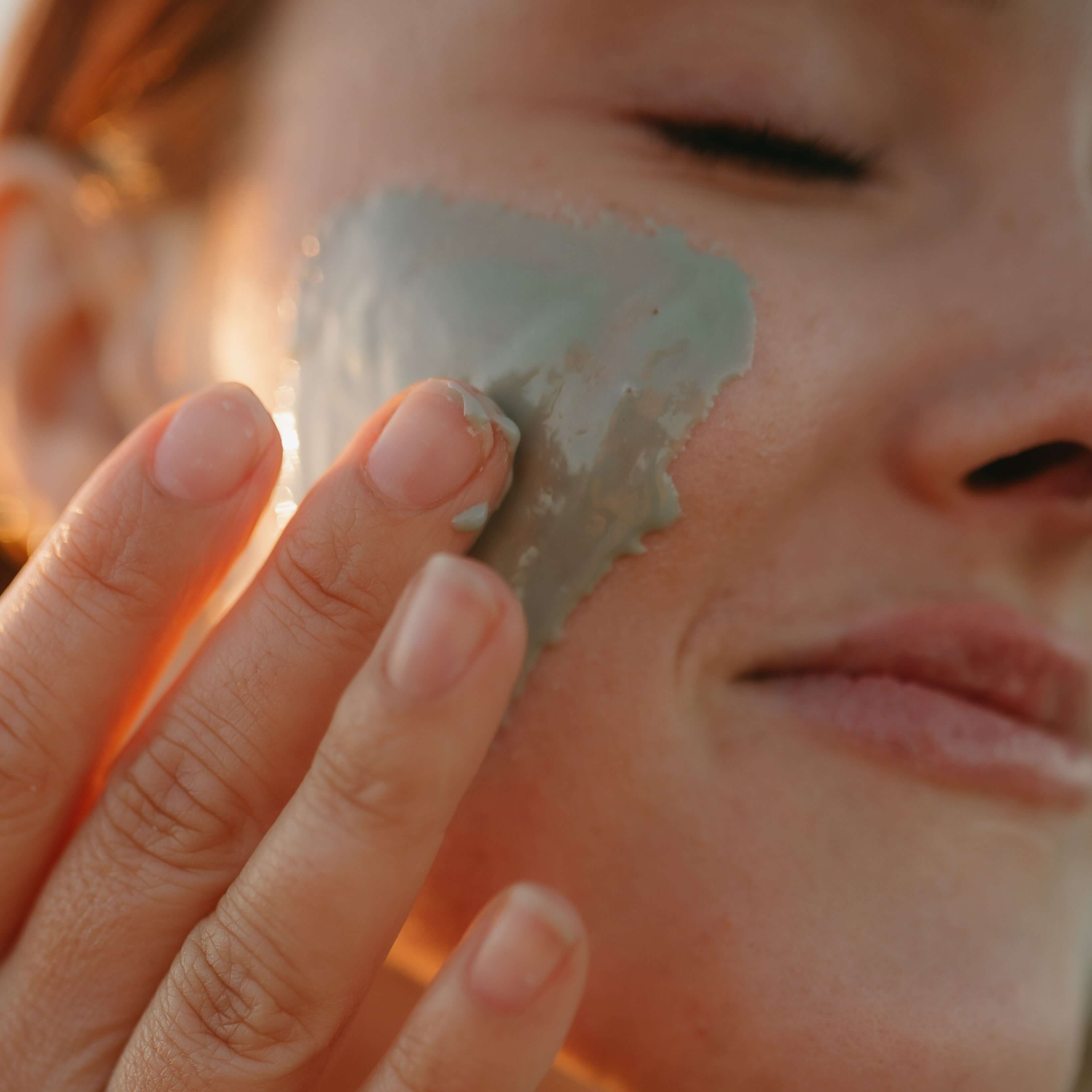 woman-applies-raw-honey-face-mask-to-her-cheeks