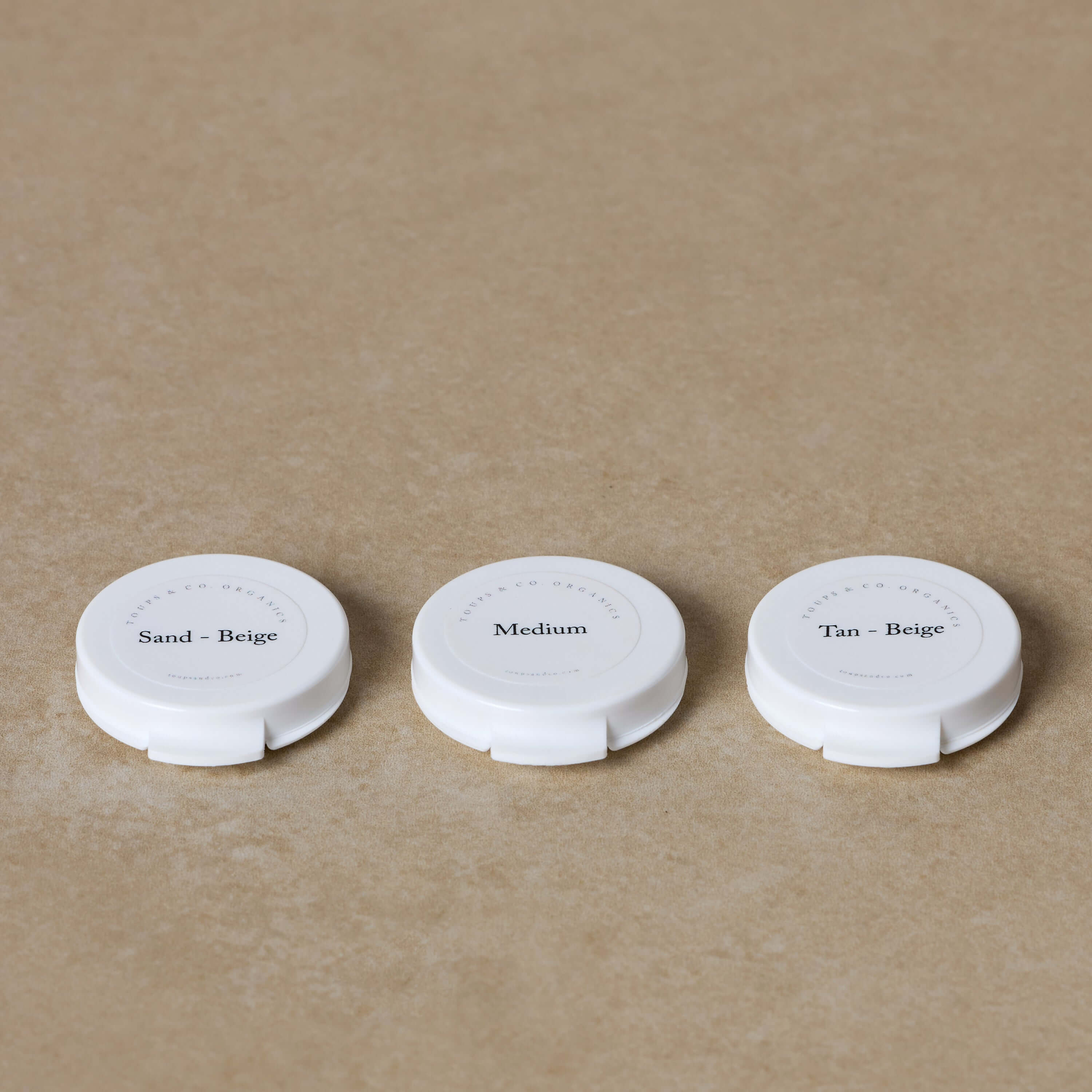 Sampling Foundation In Store Three white compacts labeled Sand-Beige, Medium, and Tan-Beige from ...