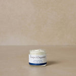 small-unscented-tallow-balm-jar-displayed-against-brown-background