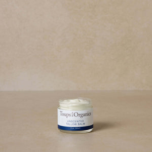 small-unscented-tallow-balm-jar-displayed-against-brown-background