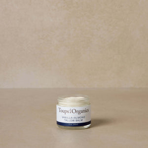 small-vanilla-and-almond-tallow-balm-jar-displayed-against-brown-background