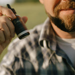 man-holds-nontoxic-beard-oil-for-men-up-for-display