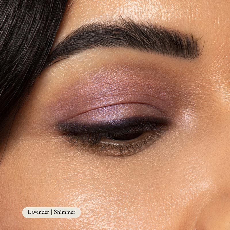 Close-up of a persons closed eye with Toups and Co Organics Natural Eyeshadow Singles in lavender blended on the eyelid and subtle eyeliner along the lash line.
