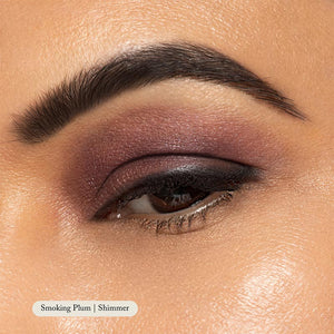 Close-up of an eye with a well-groomed brow, plum and shimmer eyelid makeup, and precise black eyeliner. Natural Eyeshadow Singles by Toups and Co Organics give a highly pigmented, naturally blended eyeshadow look.