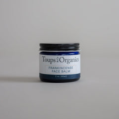 A jar of tallow balm infused with frankincense essential oil.