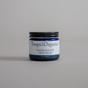 A jar of tallow balm infused with frankincense essential oil.