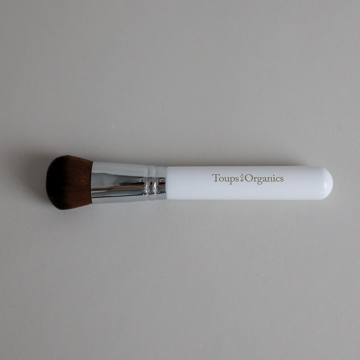 Toups & Co non-toxic makeup brush with white handle for buffing mineral foundation