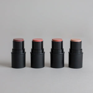 Four Toups & Co cheek tints displayed in a range of flattering shades against a clean grey seamless background. The minimalist product image highlights versatile cream makeup designed for an effortless, natural makeup look.