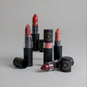 Toups & Co clean lipstick bullets in red, rose, and berry shades with caps removed