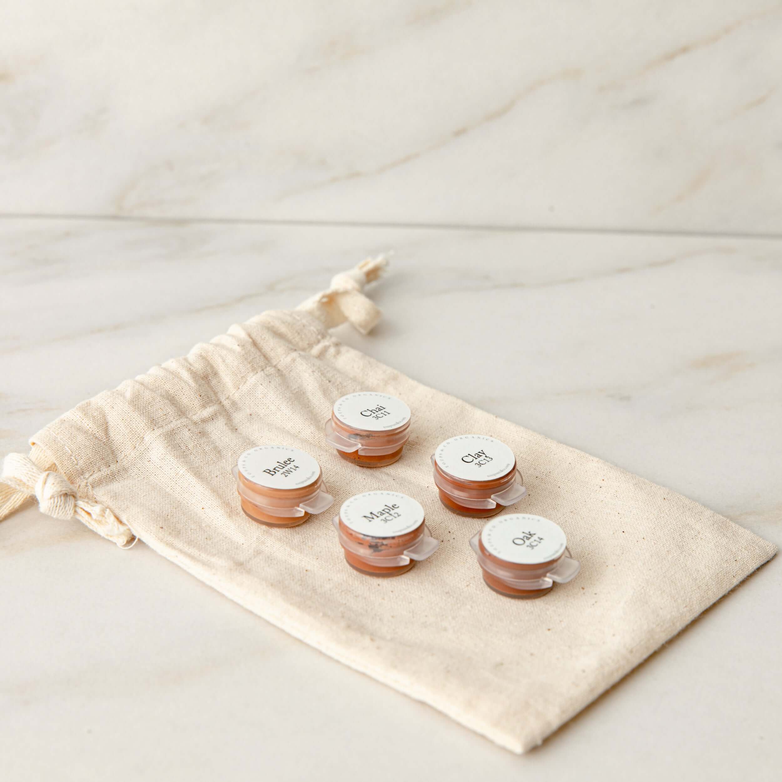 five-dark-mini-foundation-samples-sitting-on-burlap-bag