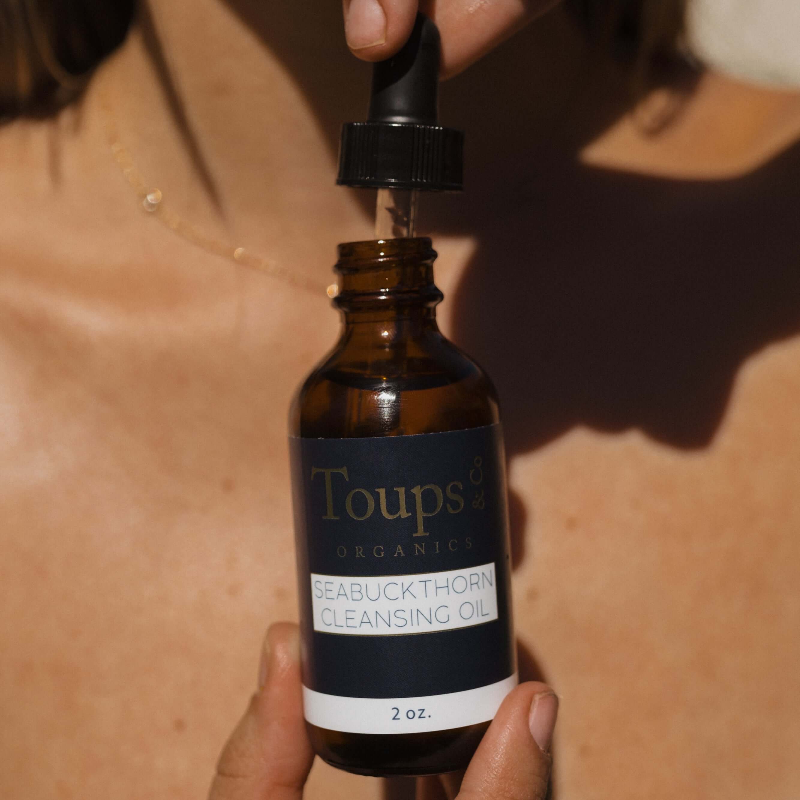 woman-holds-bottle-of-seabuckthorn-face-oil