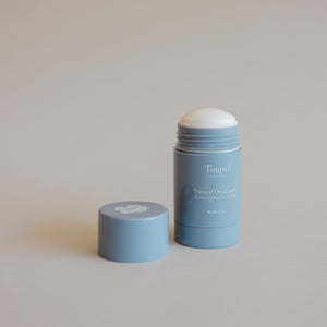 A blue stick of Toups and Co Organics Natural Deodorant with its cap beside it on a neutral background, ideal for those seeking a natural deodorant suitable for sensitive skin.