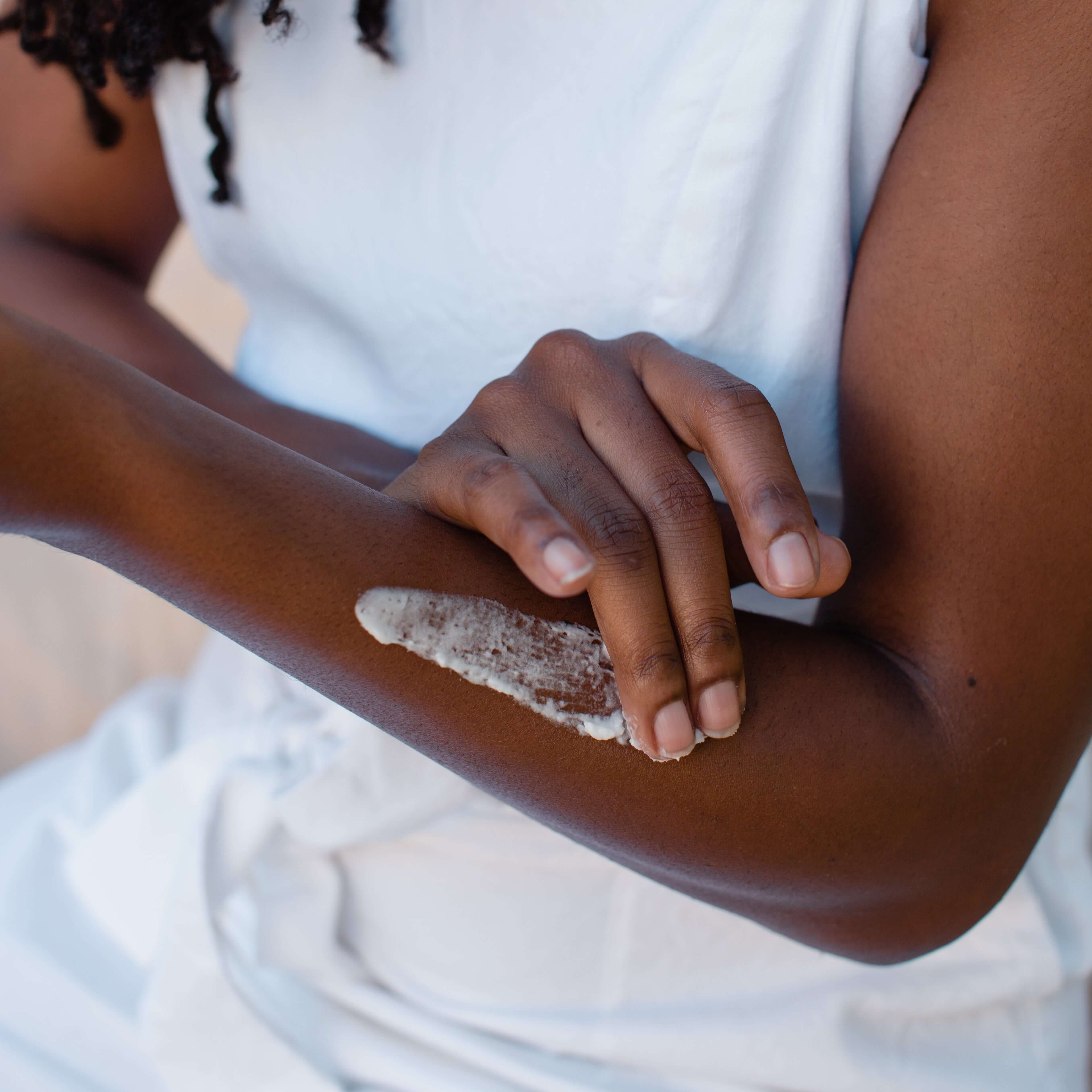 woman-applies-frankincense-tallow-balm-to-her-arms