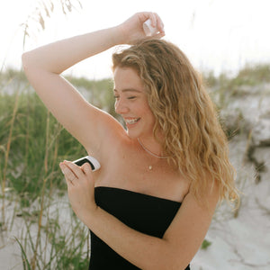 woman-smiles-while-applying-nontoxic-deodorant