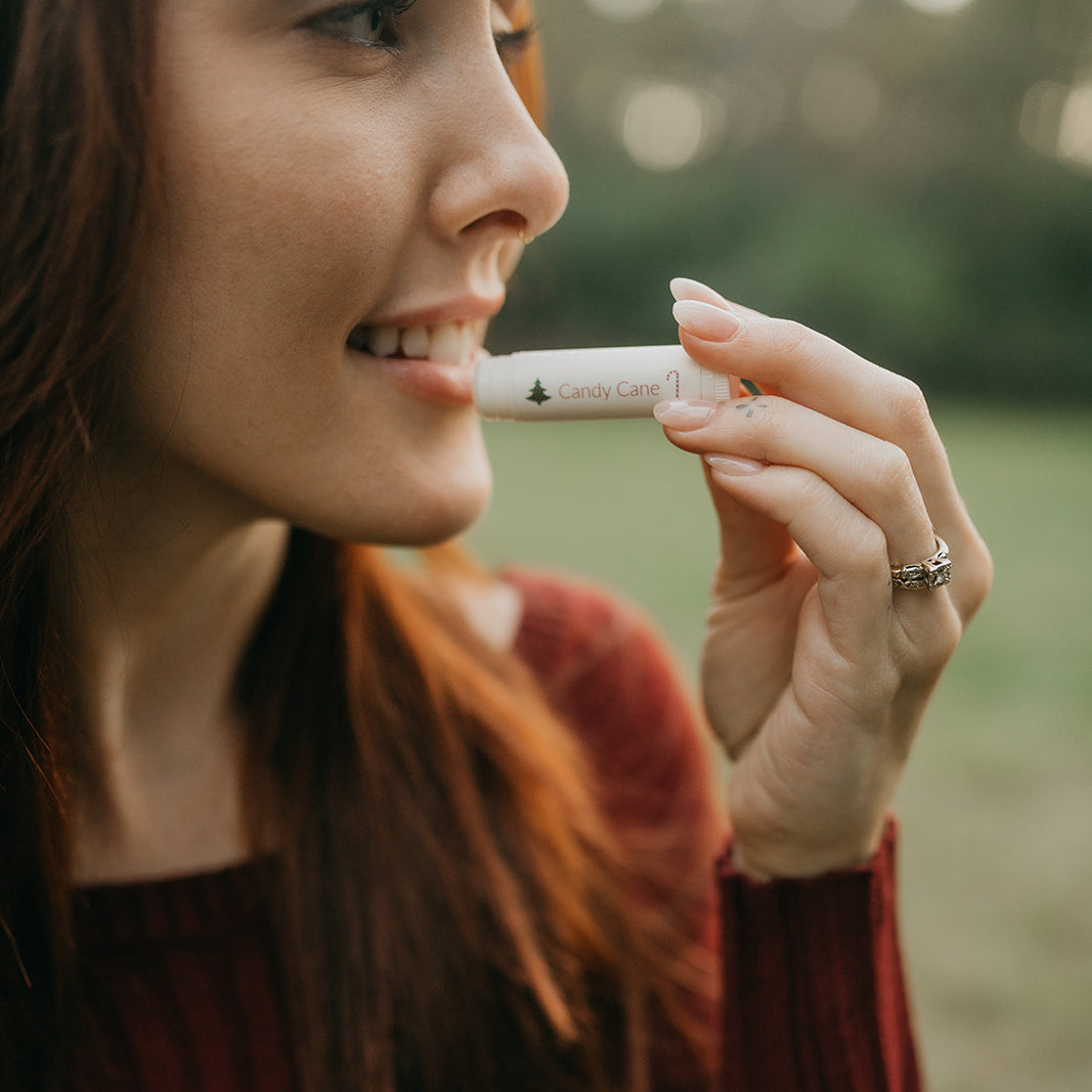 woman-applies-candy-cane-tallow-lip-balm-to-her-lips